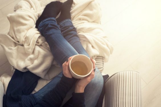 woman-couch-winter-tea-cosy_feature-565x376